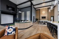 Elegant and spacious communal area with high ceilings, modern seating.