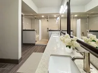 Luxurious bathroom with a sleek double vanity, modern fixtures, and a spacious walk-in shower, creating a spa-like retreat.