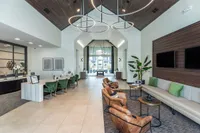 Luxurious apartment lobby with contemporary design, featuring elegant seating, modern lighting fixtures, and stylish decor.