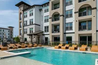 Caroline Florence | Apartments in McKinney Texas | Resort‑style swimming pool with lounge seating at Caroline Florence