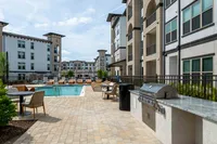 Caroline Florence | Apartments in McKinney Texas | Resort‑style swimming pool with lounge seating at Caroline Florence