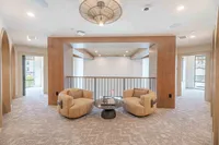 Luxurious apartment interior featuring cozy armchairs, elegant decor, and spacious design.