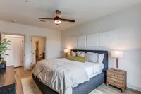 Inviting bedroom with elegant decor, featuring a king-sized bed, plush pillows, and serene lighting for a cozy and modern atmosphere.