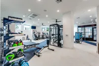 Modern fitness center featuring state-of-the-art equipment, ample space, and stylish design for an invigorating workout experience.