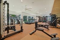 Modern, well-equipped gym with state-of-the-art fitness machines and ample natural light, perfect for an active lifestyle.