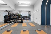Luxurious fitness studio featuring sleek yoga mats, mirrored walls, and a complete range of workout equipment at Caroline Pompano Beach.
