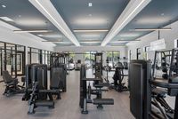 Modern fitness center featuring state-of-the-art gym equipment, sleek design, and natural lighting with outdoor views.