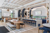 Chic and modern communal area with stylish seating, elegant lighting, and wooden accents offering a welcoming atmosphere.