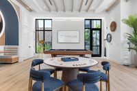 Chic and inviting game room featuring stylish seating, a sleek pool table, and modern decor in a bright, spacious setting.