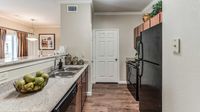 Modern apartment kitchen with granite countertops at Bennett Baytown