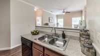 Apartment kitchen overlooking the living area at Bennett Baytown