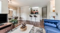 Apartment living room with open kitchen and dining area at Bennett Baytown