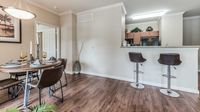 Apartment kitchen with breakfast bar and open living space at Bennett Baytown