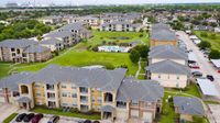 Aerial view of apartment clubhouse and surrounding residential buildings