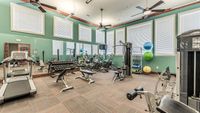 Apartment fitness center with treadmills, ellipticals, free weights, and strength equipment