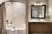 Bathroom with soaking tub, marble-look tile and wood vanity
