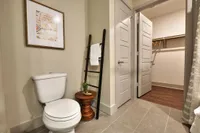 Bathroom with toilet, towel ladder and walk-in closet