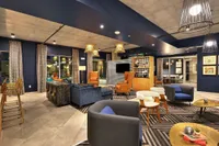 Clubhouse lounge with sofas, bar seating and pendant lights