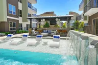 Pool sun shelf with lounge chairs, waterfall wall and cabana, Houston, TX