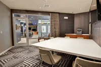 Conference room with work table, chairs and glass doors to the clubhouse