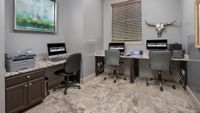 Modern apartment workspace featuring sleek granite countertops, computer stations, and stylish decor for productive living.