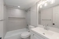 Beautiful white updated bathroom at The Falls at Roland Park Apartments for Rent