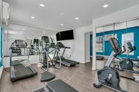 Gym with mirrored walls and equipment