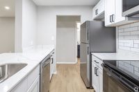 Upgraded Kitchen with White Quartz Counters in an Autumn Columbia apartment.
