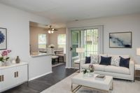 Large open floor plan with wood flooring throughout Countertops and White Cabinetry at Autumn Town Center Columbia apartments.