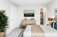 Open Light-Filled Layout with Faux Wood Style Flooring in an Autumn Town Center apartment.