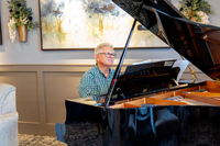 Resident Playing Piano at Attivo Trails Ankeny | Ankeny, Iowa
