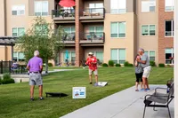 Residents Playing Cornhole | Attivo Trails Waukee | Waukee, Iowa