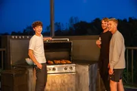 Friends Enjoying the Grill | Sky Deck at Core Apartments