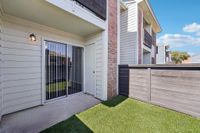 private patio with grass and fence