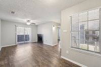 wood burning fireplace inside spacious living room with access to outdoor patio