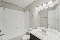 bright and clean bathroom with tub and shower