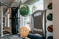 Fitness Center with exercise machines, stability balls, resistance bands, and fitness mats