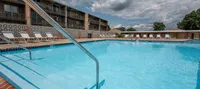 Relaxing poolside at Woodmere Apartments