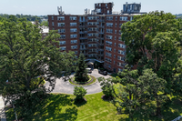 Exterior view of a 55+ apartment complex on the Main Line in Philadelphia with landscaped grounds.