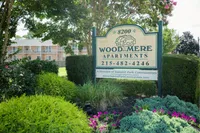 Outdoor entrance sign for Woodmere Apartments in Roxborough