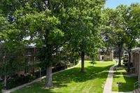 Spacious balcony at Woodmere Apartments with seating are