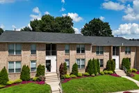 Lush green lawns and gardens at Woodmere Apartments