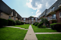 Front view of Valley High Apartments showing private entrances and scenic landscaping