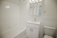 Renovated bathroom with sleek fixtures at Conwyn Arms Apartments in Bryn Mawr PA
