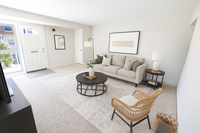 Bright and inviting living room with neutral tones, featuring a comfortable sofa, modern coffee table, and stylish decor.
