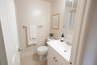 Elegant bathroom with modern fixtures, featuring a sleek vanity, stylish decor, and soft lighting.