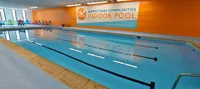 Vibrant indoor pool with colorful seating at Summit Park Communities, offering a perfect space for relaxation and recreation.