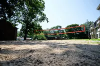 Inviting outdoor sand volleyball court surrounded by lush greenery, perfect for recreational activities and relaxation.