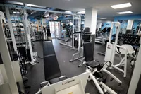 Modern fitness center with high-quality exercise equipment and ample natural light, perfect for an invigorating workout.