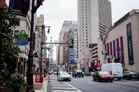 Vibrant urban cityscape with bustling street scene, tall buildings, and iconic architecture in background, ideal for city living.